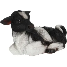 Veau noir et blanc couché en résine