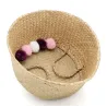 Panier rond en jonc naturel avec pompons